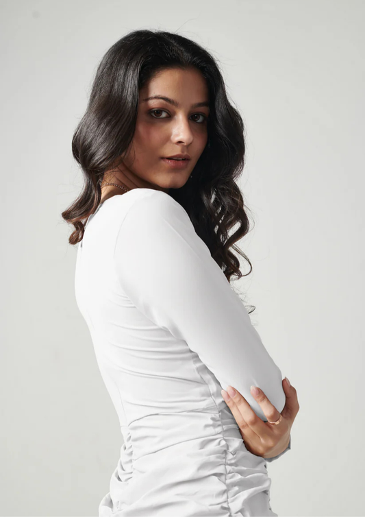 Siora fitted white lycra dress with flattering ruching and bust shape—ideal for brunch dates, clubbing, or romantic evenings.