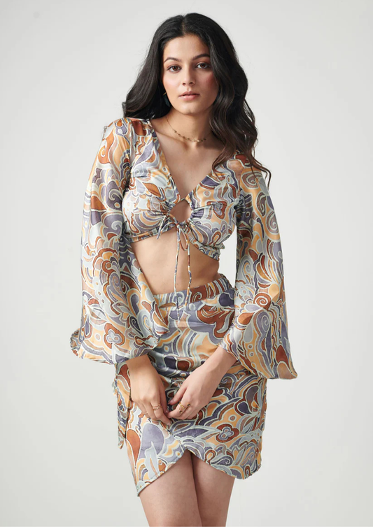 Siora two-piece printed outfit in semi satin georgette featuring flared sleeve crop top and ruched tie-front skirt—fun and flirty fashion for any outing.