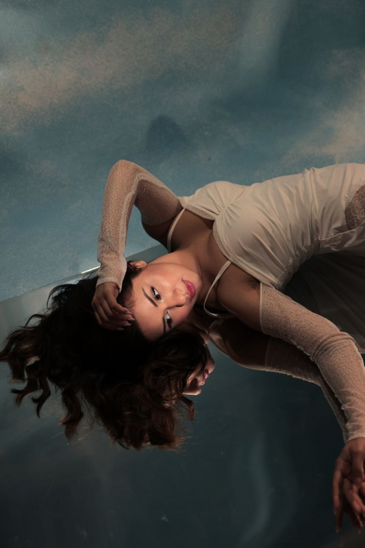 Avneet Kaur stuns in Seora’s Winter Snow Dress—featuring a sleek white silhouette, sheer net sleeve details, and a dramatic side slit, ideal for holiday parties and festive occasions