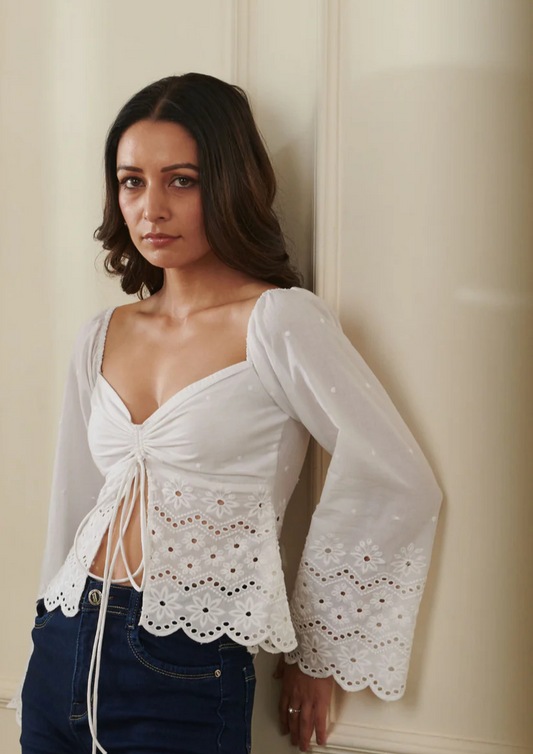 "Siora elegant white chikankari embroidered cotton top with flowy flared sleeves and a stylish front slit—ideal for beach getaways, day parties, and chic travel looks.
"