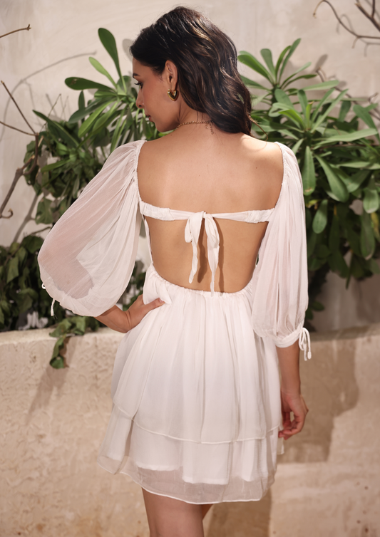 Seora White Short Dress with a flattering rushed bustier design and playful tie bow at the back, ideal for brunches, romantic dates, beach parties, or casual get-togethers.
