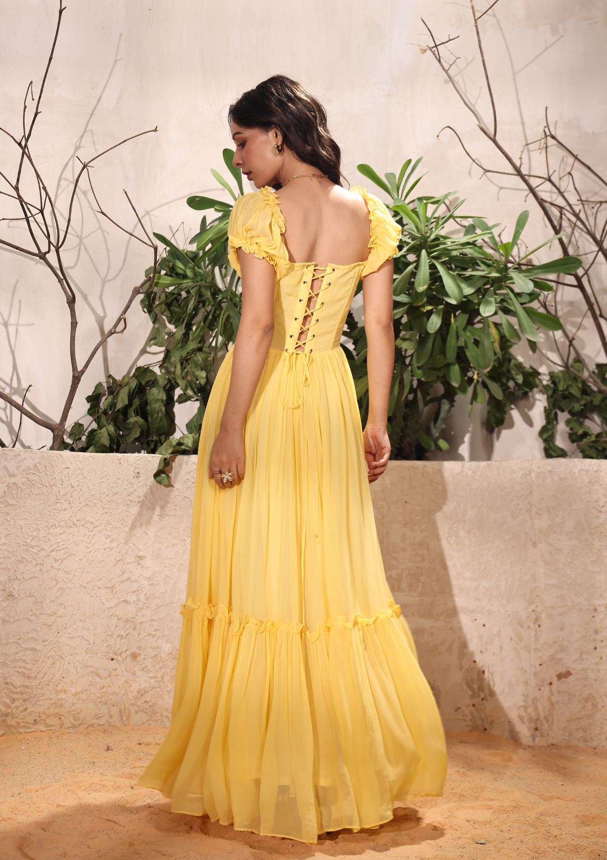 Siora stunning yellow maxi dress featuring a bustier top, crisscross back, and delicate frills—perfect for Haldi ceremonies, summer vacations, and birthday parties