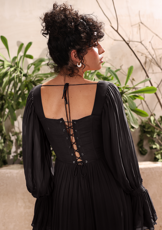 Seora Black Gown Maxi Dress featuring a corset bodice, ruched sleeves, and a flowing tiered skirt – an elegant choice for summer events, romantic dates, or luxurious lounging