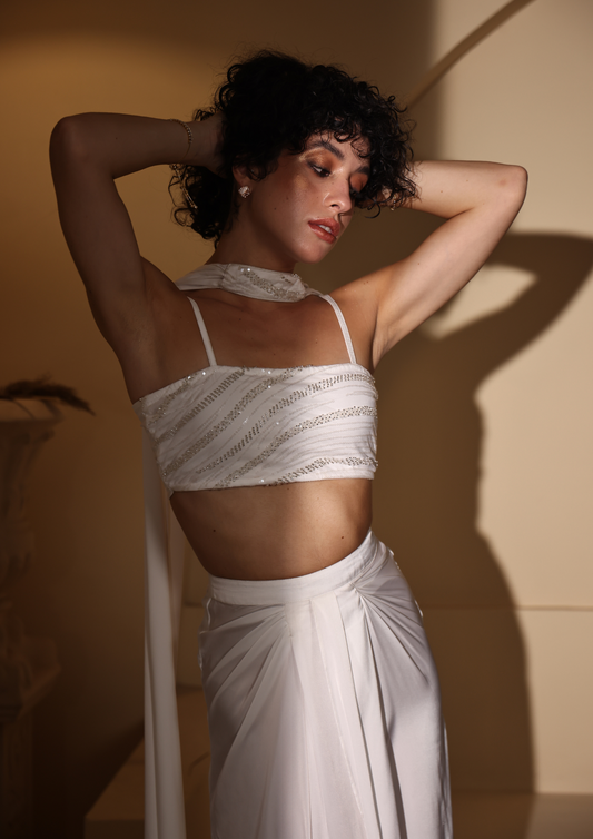 Seora Luxe sophisticated white Nisma Co-ord Set, designed with a front-slit draped skirt, embroidered tube top with delicate straps, ruched back, and a statement collar dupatta—ideal for festive occasions, sangeet functions, and luxury soirées