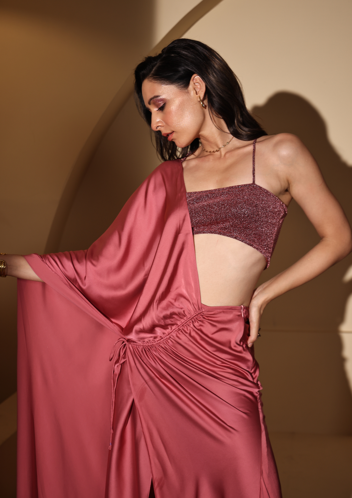 Siora Luxe glamorous pre-draped Aqsa Saree in soft blush pink with a chic one-shoulder design, cinched waist, and a shimmering blouse—designed for weddings, mehendi, and upscale celebrations