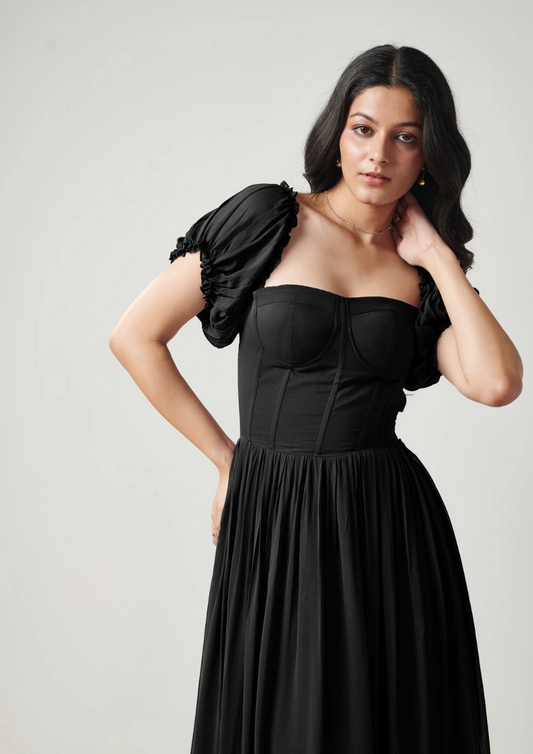 Theresa Long black gown featuring sweetheart neckline, criss-cross back tie, and elegant layers—perfect for date nights and chic celebrations.