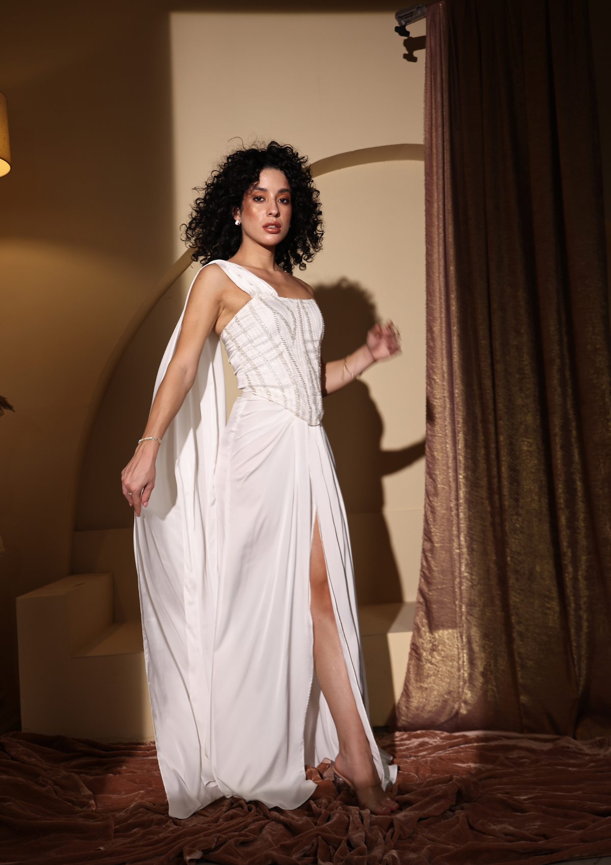 Seoraa Luxe elegant Inaya Armani Set in pristine white, featuring a silver-embroidered structured corset with boning, a draped floor-length skirt with a front slit, and a flowy attached dupatta—perfect for Diwali, sangeet functions, and upscale events