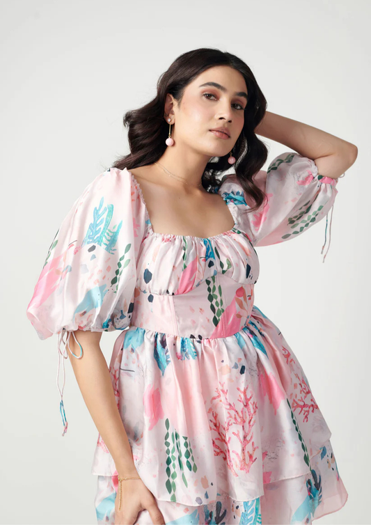 "pink-hued Kierra bustier frock by Siora—semi satin georgette fabric with ribbon tie back and elegant bell sleeves for a fun, chic vibe.
"