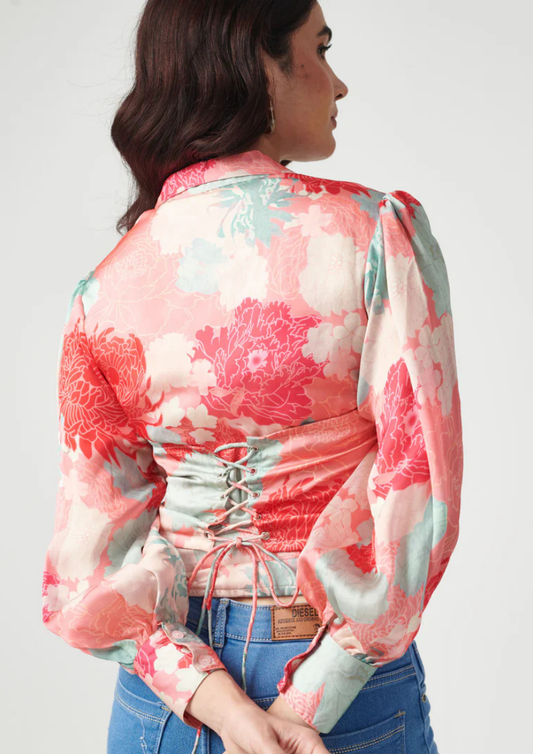 "Siora vibrant pink floral corset-style shirt featuring a waist-cinching fit and playful back tie—ideal for birthday brunches, tropical getaways, and festive gatherings.
"