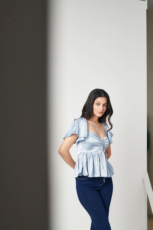 Siora Haze Satin Top - Blue Satin Peplum Top with Cap Sleeves & Bust Gather Details: Sophisticated and playful top for brunches, holidays, and stylish summer outings.