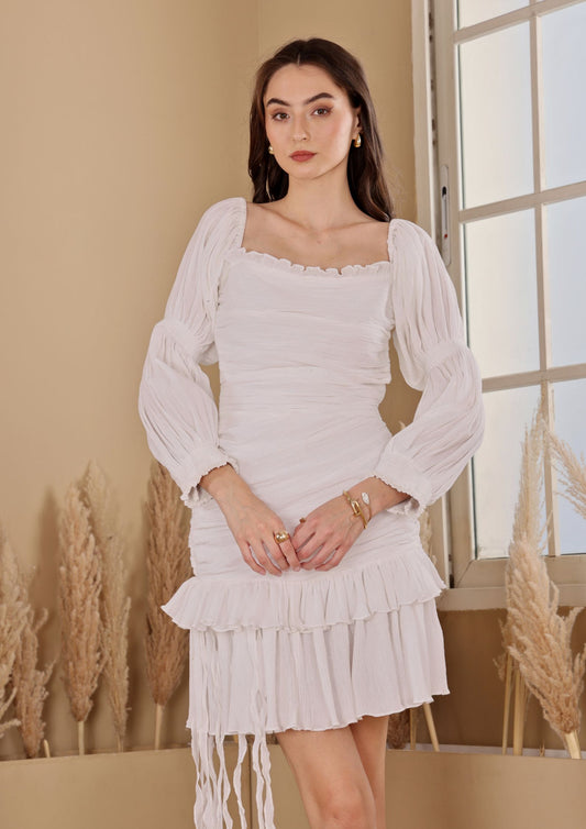 Siora Ivory Dress with asymmetrical ruffle hem and tie details, perfect for sunset dates