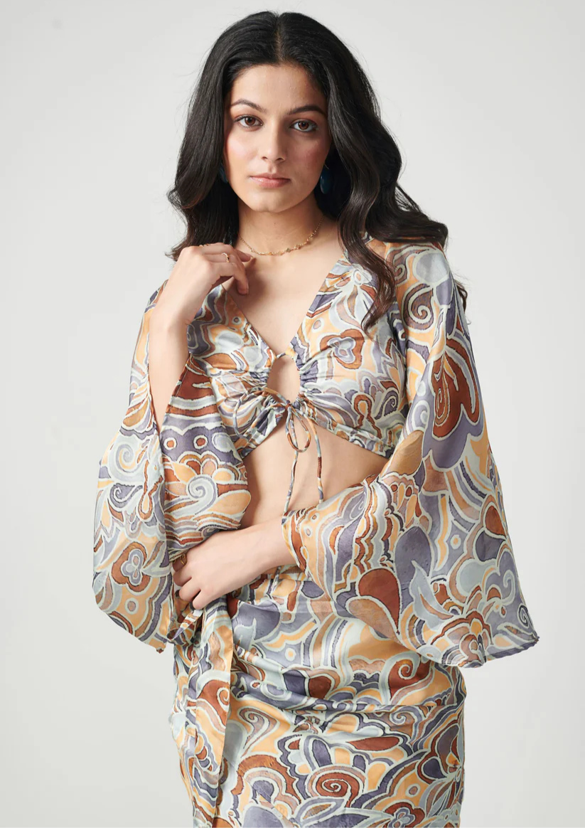 Seoraa Noelani printed co ord set with flared sleeve crop top and ruched wrap-style skirt in semi satin georgette—perfect for a playful day look.