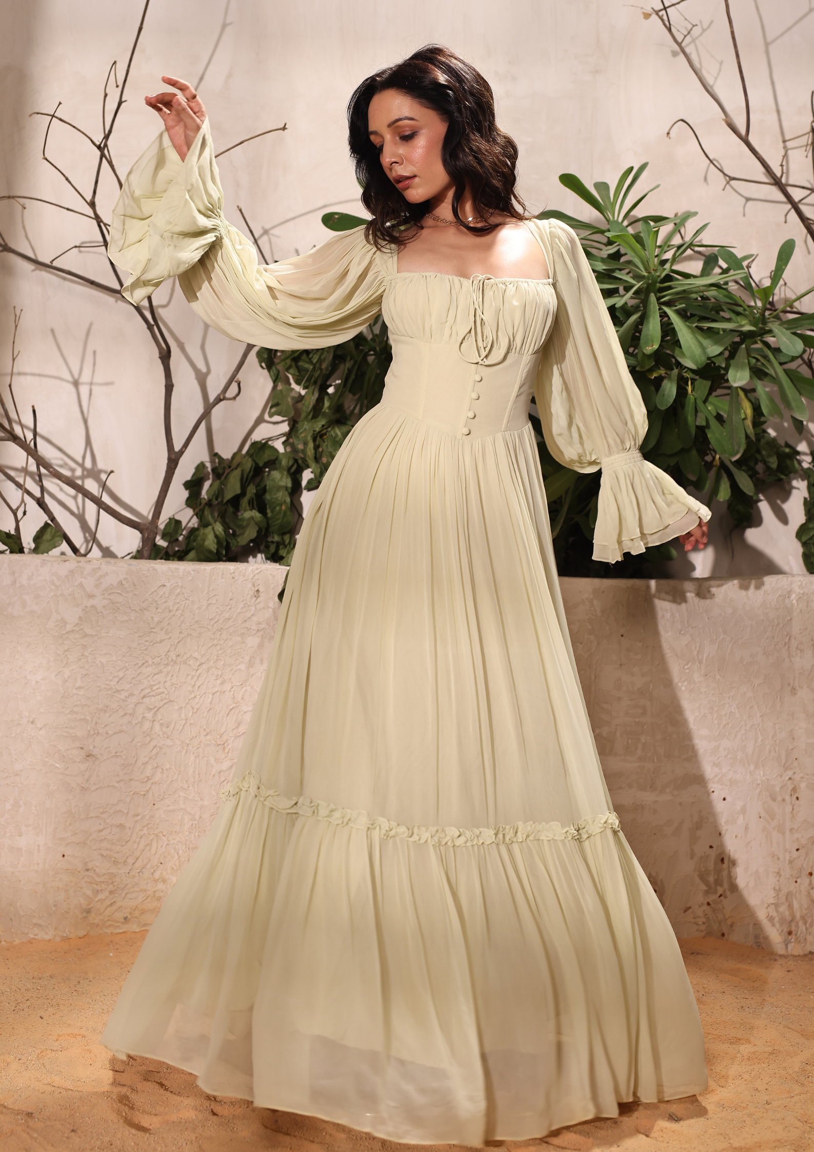 Seoraa Green Maxi Gown Dress featuring a corset-style bodice, delicate button details, and frill accents on the sleeves – perfect for bridesmaid, weddings, elegant evening events, and upscale gatherings.