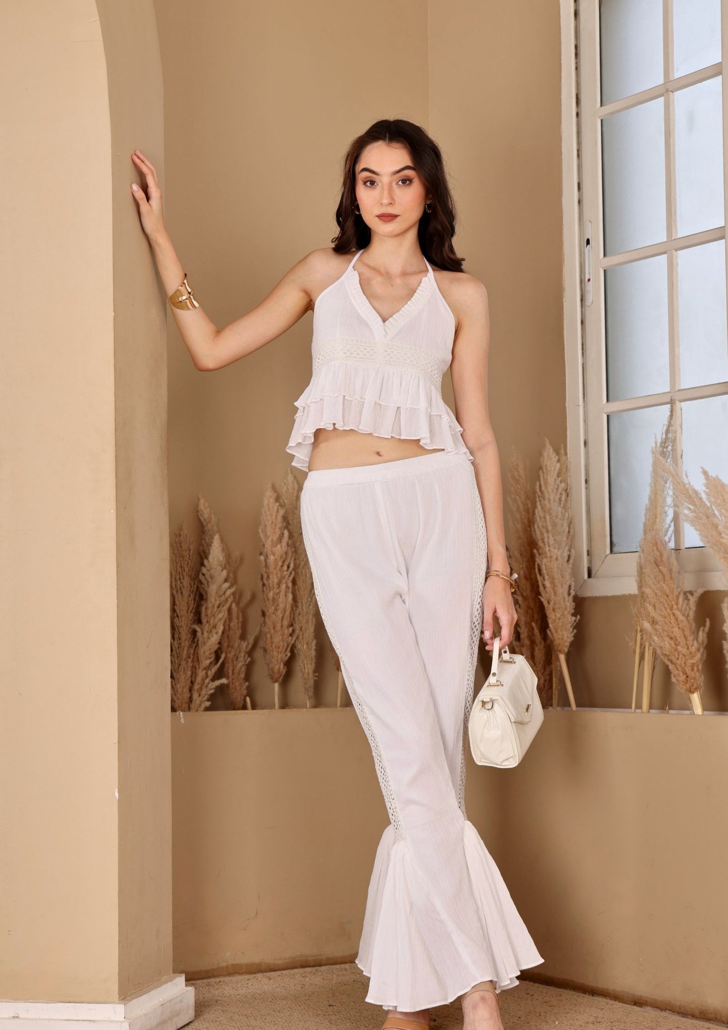 Seoraa White Co-ord Set with halter top and high waisted flared pants, perfect for beach vacations