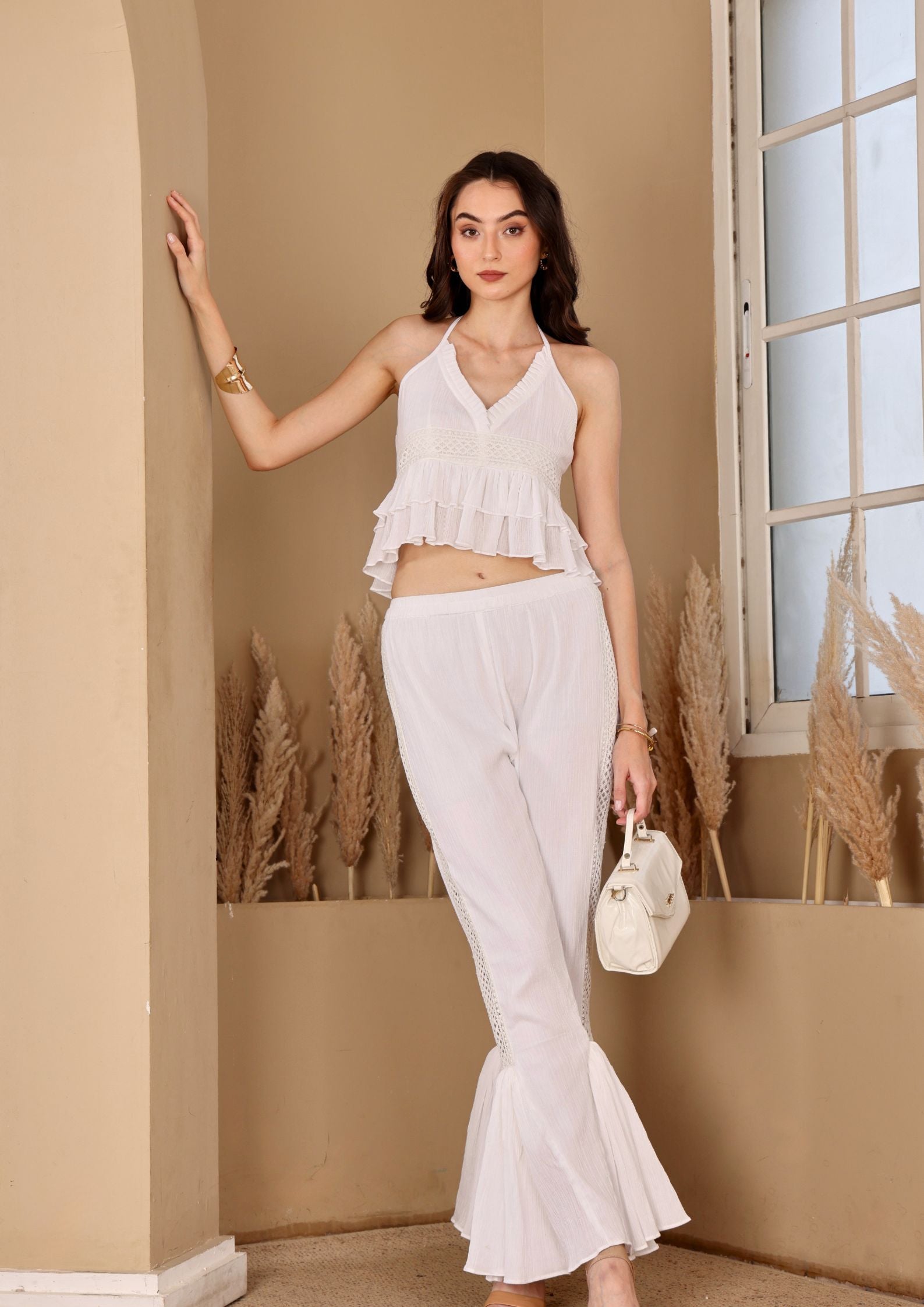 Seoraa White Co-ord Set with halter top and high waisted flared pants, perfect for beach vacations